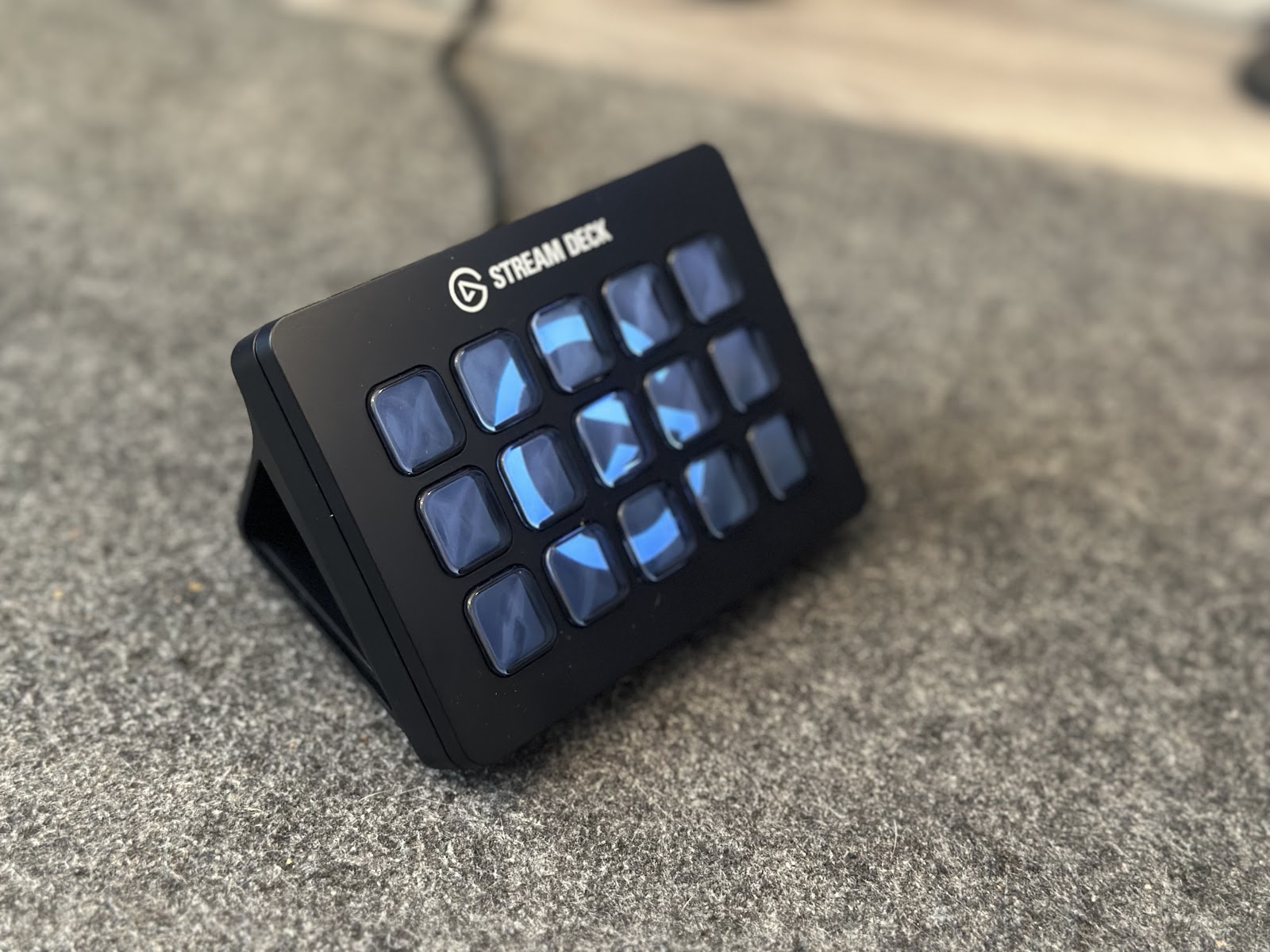 James's photo of his Elgato Stream Deck on a grey desk mat, fifteen LCD keys glowing blue.